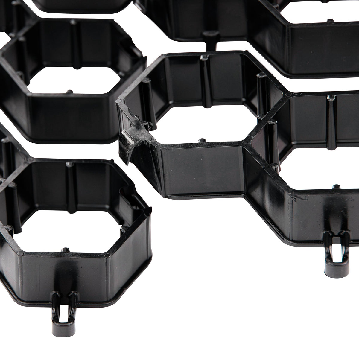 Close-up of NDS EZ Roll grass paver hexagonal cells and locking clips